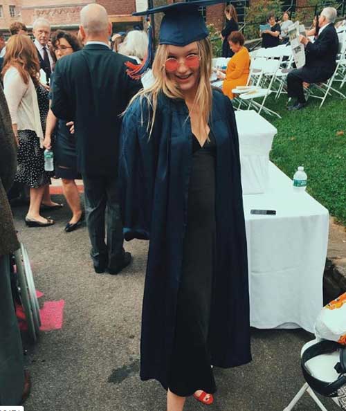 Madelaine West taking a photo on her graduation day.
